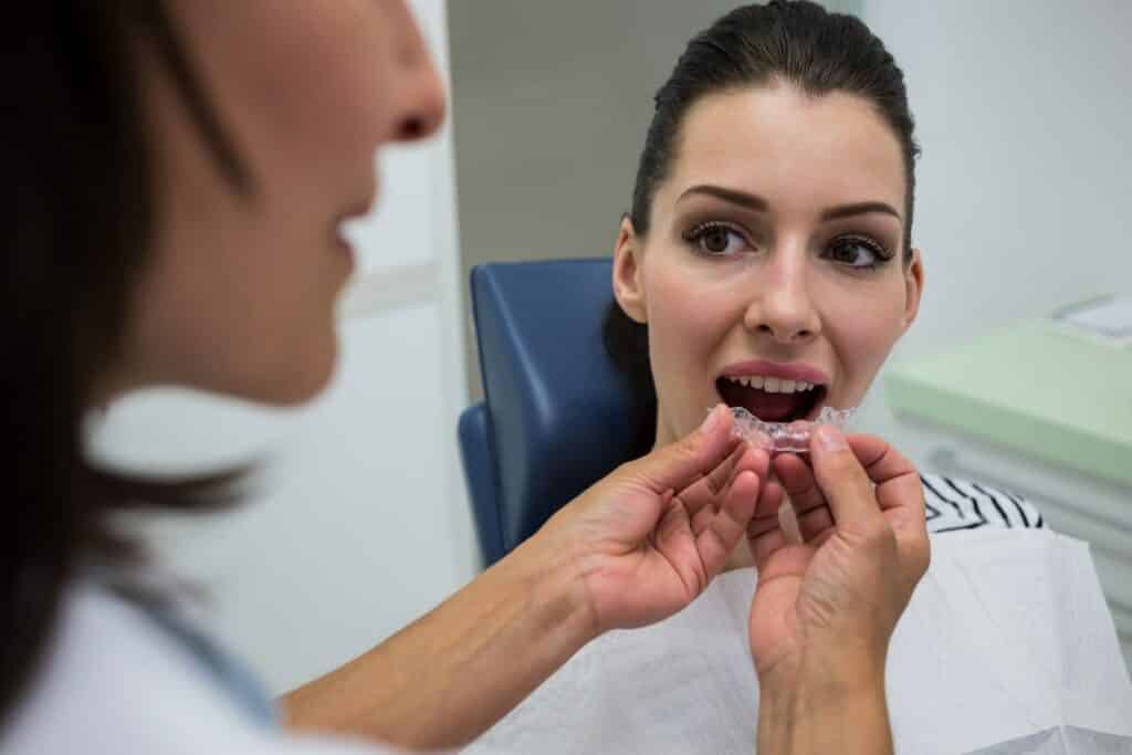 dentist assisting patient wear invisible braces 107420 65666