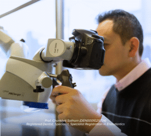 Specialist Endodontist using a dental microscope