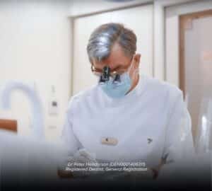 Dentist assisting a patient in clinic.
